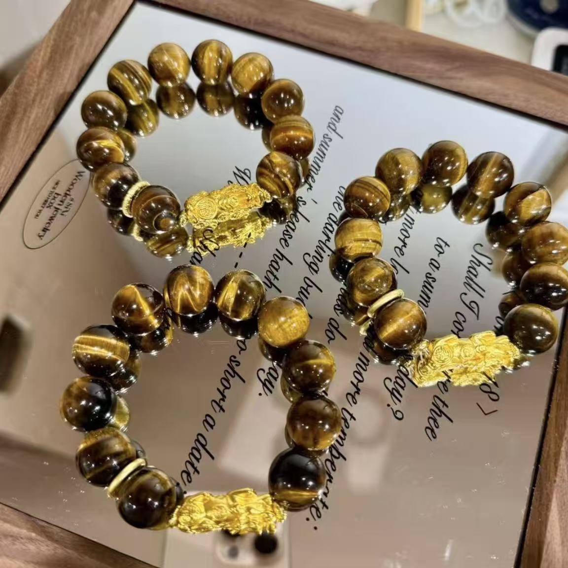Tiger eye with golden metal charm